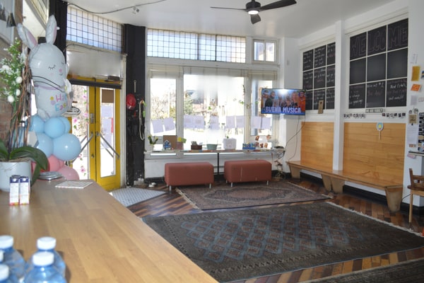 Bright Corner Storefront with Exposed Brick and Side Garden in Toronto
